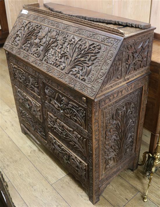 An Anglo Indian foliate carved camphorwood bureau, c.1900, W.92cm